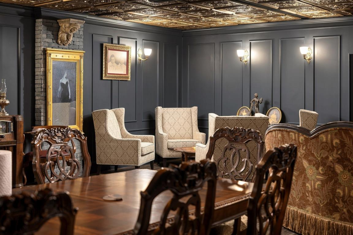 Large communal table in a paneled gathering room